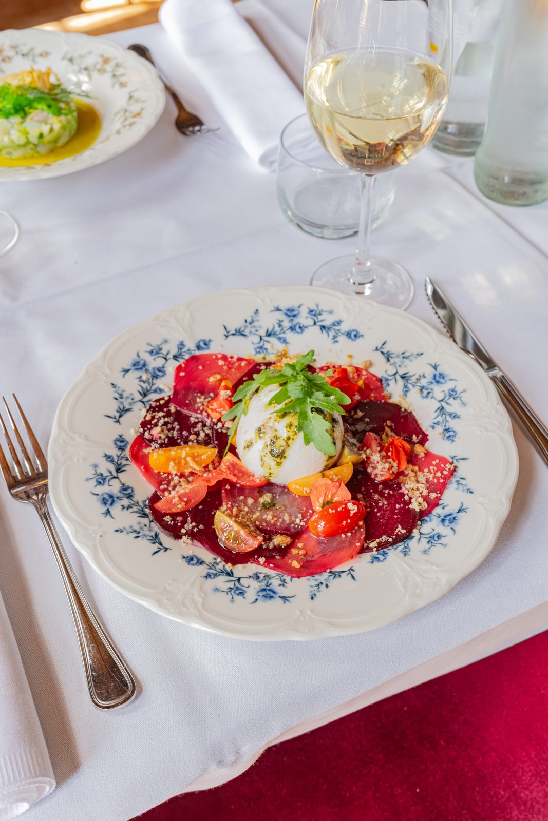 Beetroot carpaccio with burrata, cherry tomatoes and edible flowers